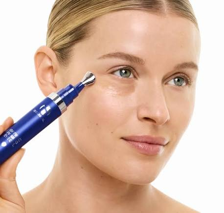 woman using iS Clinical face cosmetic