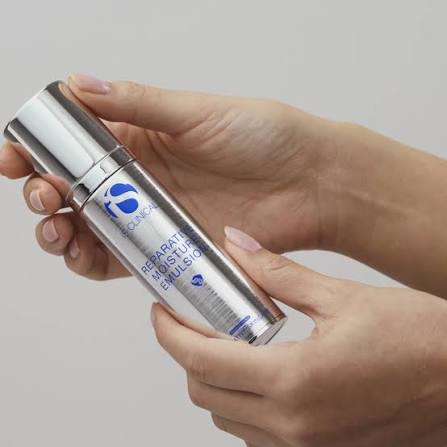 hands holding iS Clinical cosmetic