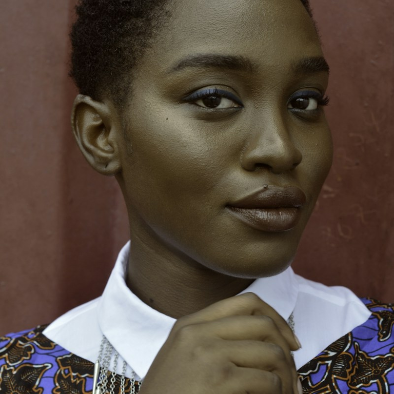black woman with short hair and white shirt